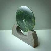 Hand carved New Zealand Marsden Jade Disc with Greywacke stand sculpture. Hand carved here in New Zealand by Ric Moor. This is a 'one only' sculpture, a beautiful display piece.